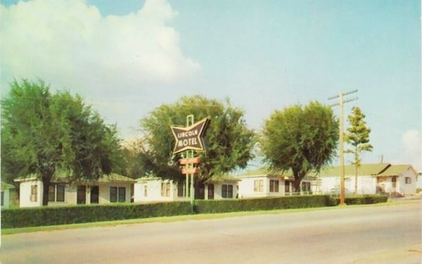 color postcard, trees cabins and neon sign of Lincoln motel