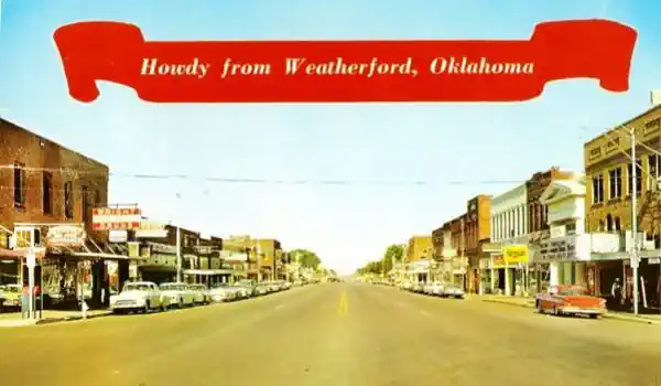1950s color postcard Main St. cars, buildings, people