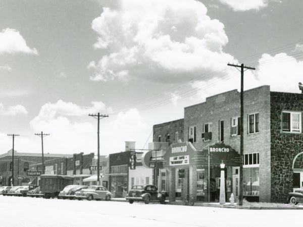 looking south along Broadway 1947 black and white photo. Cars and buildings