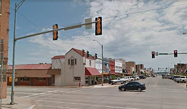 cars, buildings and Route 66 intersection with Main St. Elk City