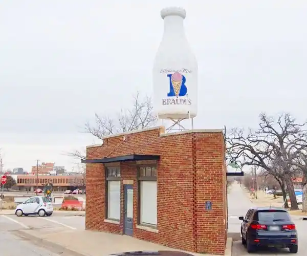 brick building with gigant Milk Bottle on flat roof