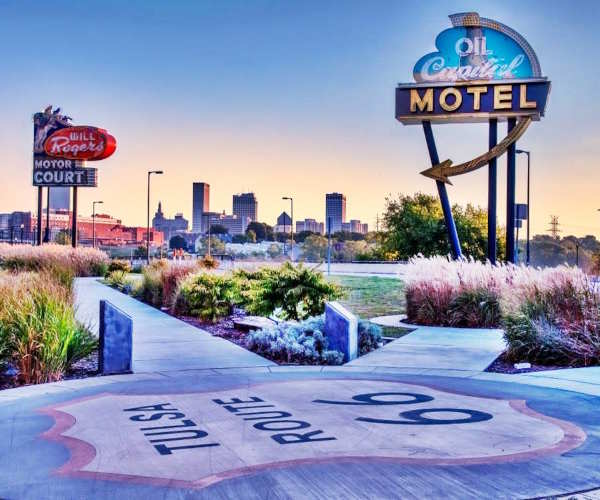 Route 66 Neon Sign Park Tulsa Route 66 salvaged neon signs in a park, Tulsa skyline beyond, Route 66 shield in sidewalk