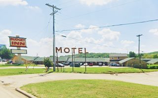 Oil Capital Motel nowadays Tulsa Rte 66 motel with neon sign and sign that reads MOTEL