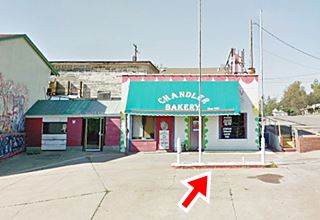 gas pump in front of old gas station repurposed as a bakery