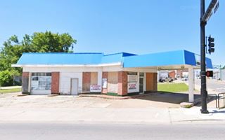 on the corner, a gas station