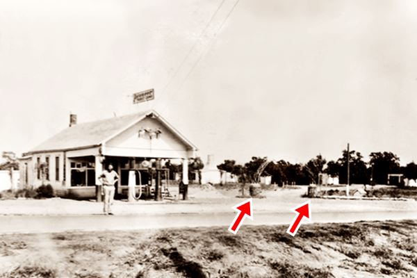 black and white 
photo 1930s man, gas station gable roof and pumps and US66 in front of them