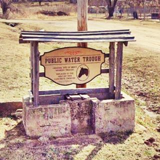 concrete trough with a roof and a sign