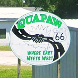 sign with shaking hands with arms like a highway and Quapaw where east meets west written on it and a US66 Shield