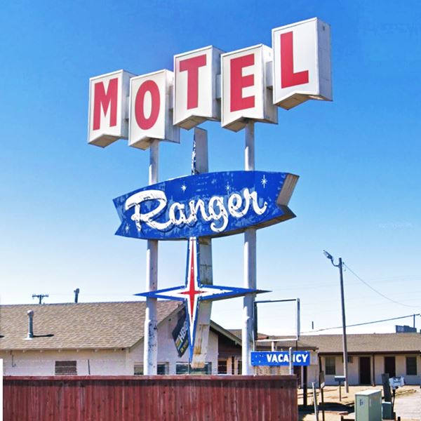 Neon sign with MOTEL written in White blocks with red letters and word RANGER in white on blue below