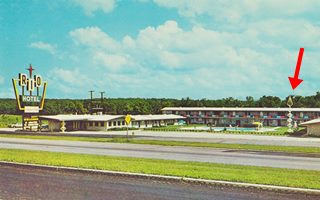 Rio Motel 1950s Tulsa Rte 66 steel structure in lawn by motel marked with red arrow. Two story with colored panels