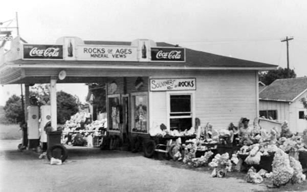 US 66 1950s gas station with canopy, pumps and also rock shop with rocks displayed. Commerce OK