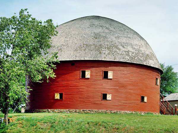 Round Barn made in wood, painted brown with a hemispherical shingle roof
