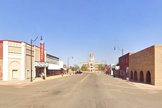 Sayre Courthouse color, street leads to domed courthouse, single story buildings, line it, deserted sidewalks