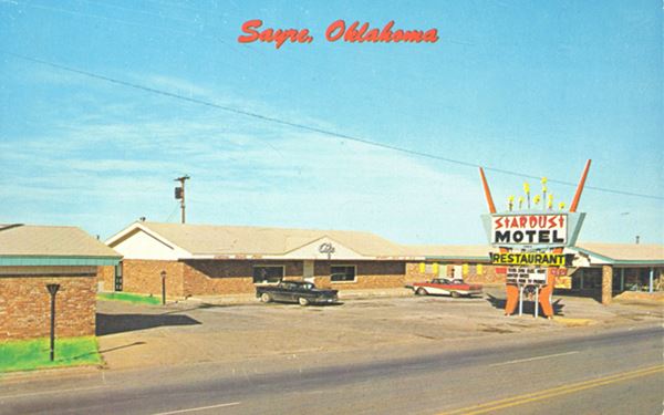 1950s postcard of the motel, its neon sign and restaurant