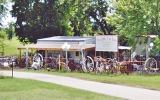 Little Tin Barn yard with ornaments and trees