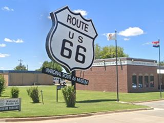 enormous black and white US Highway shield on lawn