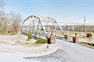 old 1936 steel span of Verdigris River bridge on Route 66, an entrance road to a restaurant