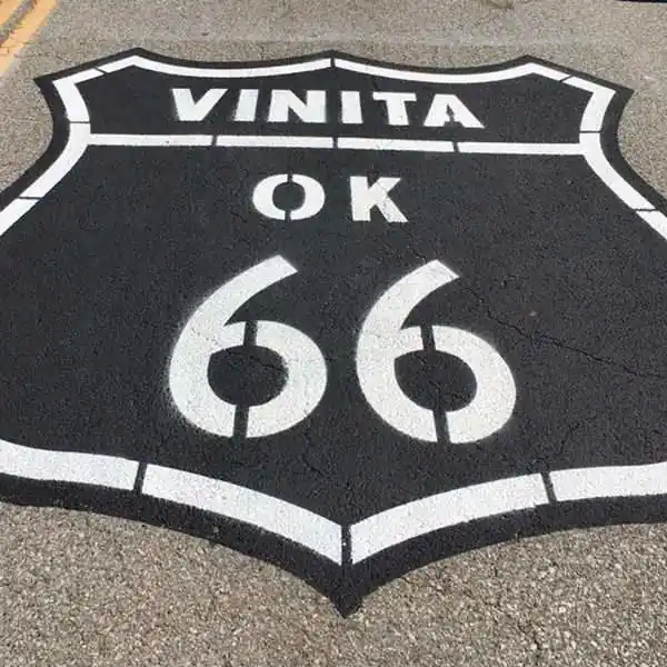 large US 66 highway shield painted on roadway