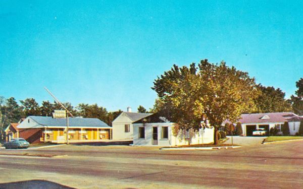 motel on a corner, Route 66 and car in a color 1950s picture
