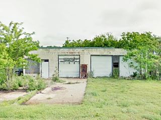 vintage US66 filling station old building among overgrown trees