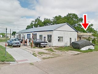 Consumer’s Supply Co. station before demolition gable roof corner gas station