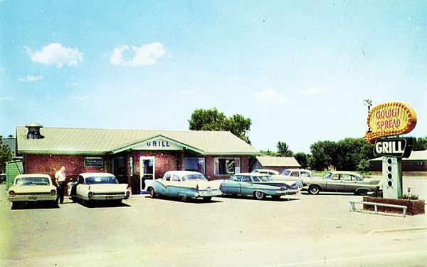 color postacard from 1960 of a gabled roof restaurant and neon sign