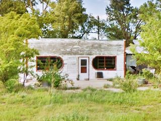 Miller’s Chevron old building among trees