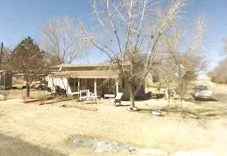 home with porch, formerly a filling station in Alanreed