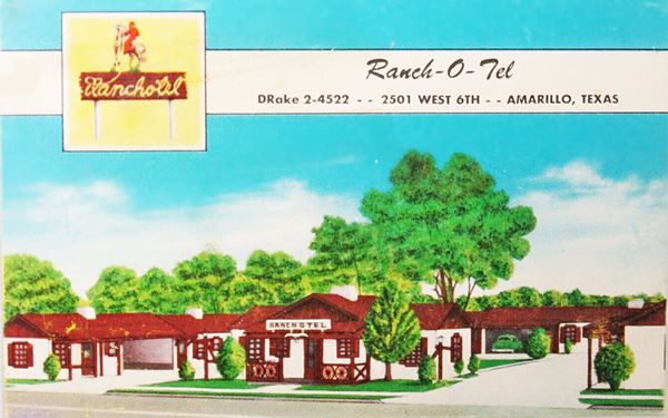 postcard gable roof motel with trees