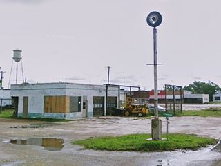 Gas station on U.S.66 oblong box station with steel post and tire on top