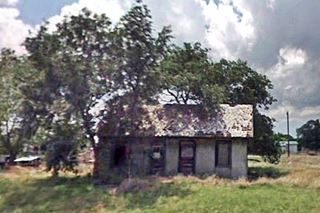 vacant ruined gabled two room cabin in Alanreed